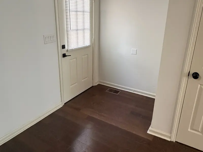 Clean entry door and refinished floor in a rental after a turnover