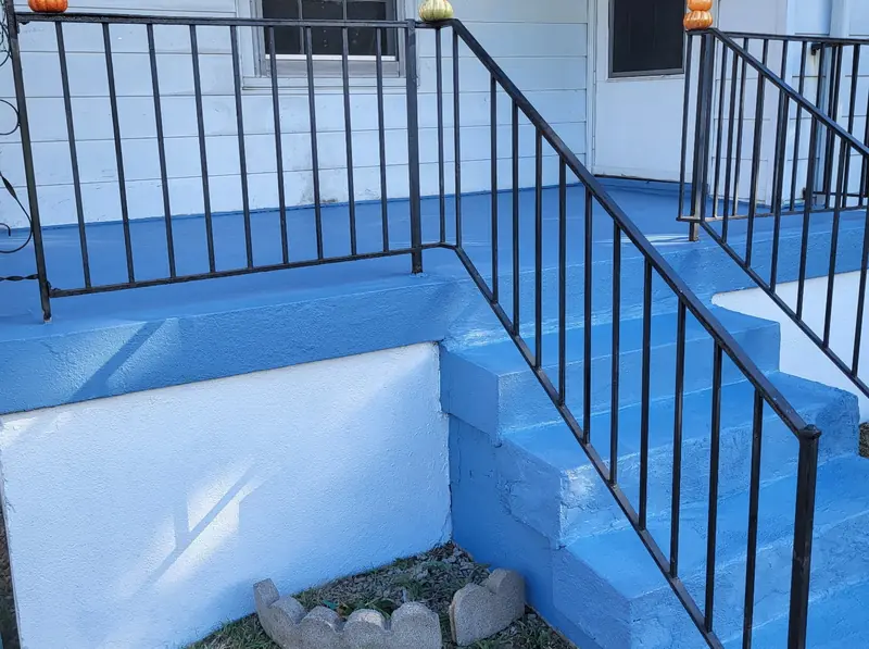 Painted porch steps and iron railing on a Louisville house