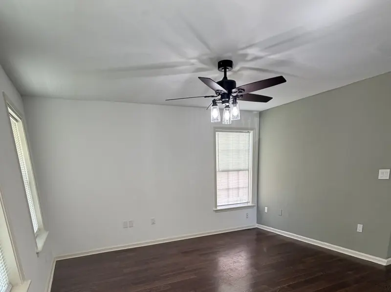 Ceiling fan with a light installed in a bright rental room