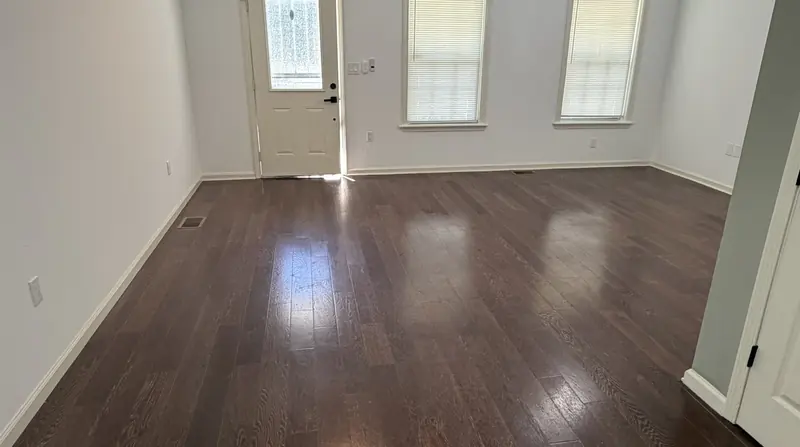 Living room in a Louisville rental with refinished floors and fresh paint