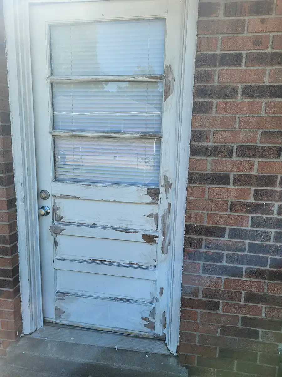 Before: Back door, scraped, primed and repainted