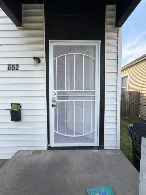 After: Entry door and storm door, repaired and cleaned, by The Tenant Turn