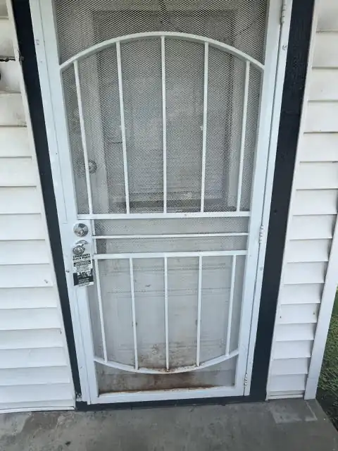 Before: Entry door and storm door, repaired and cleaned