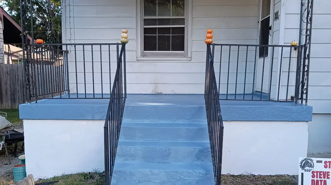 Painted front porch steps and iron railing on a Louisville house